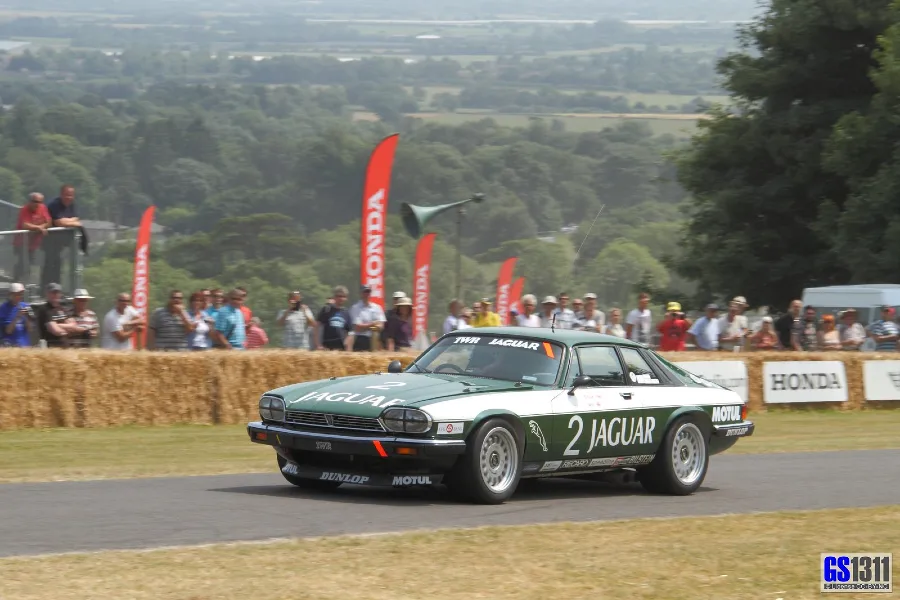 Tom Walkinshaw Racing car on a road with people in the background of the race circuit