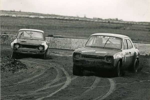Cars racing through the mud in Knockhill, black and white