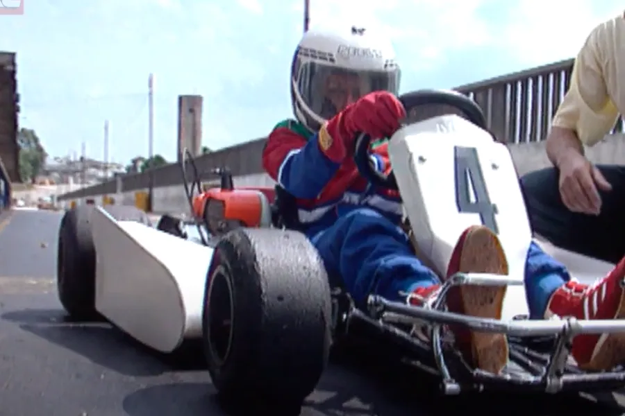 Ayrton Senna in a helmet driving a go kart